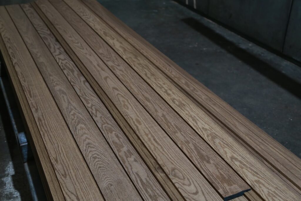 Underlayment material being rolled out on a subfloor before vinyl plank flooring installation