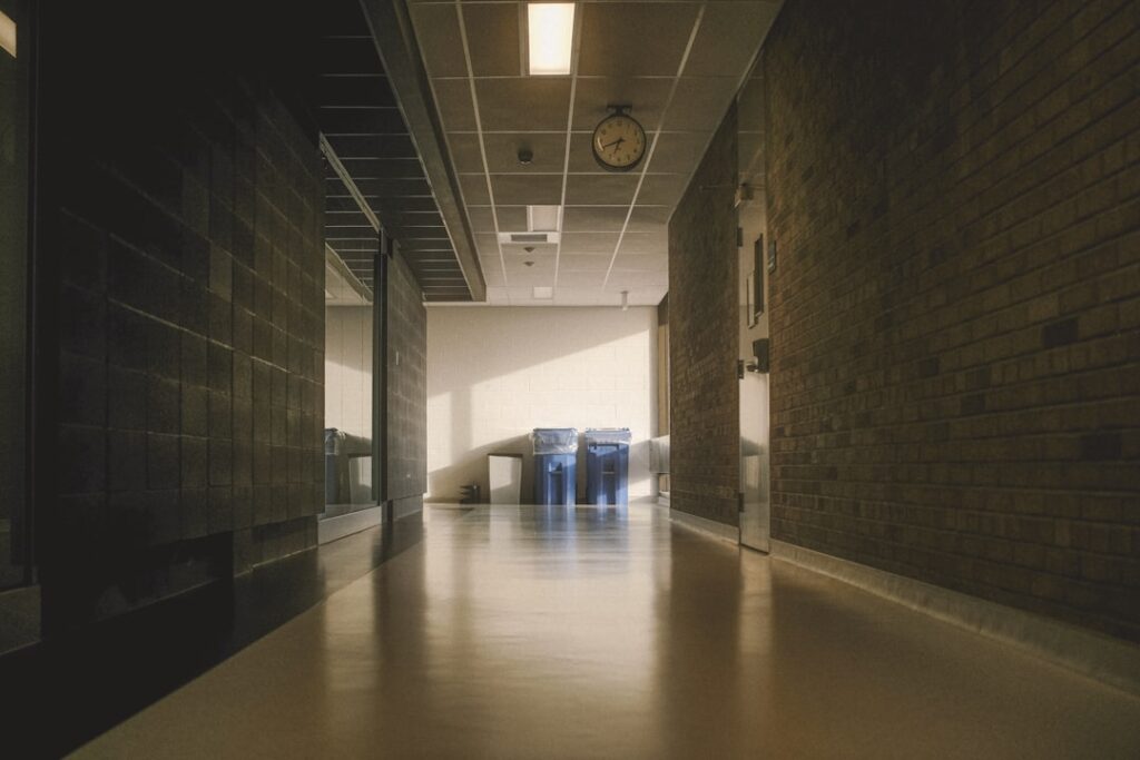 Commercial hallway with polished VCT flooring in a multi-color pattern