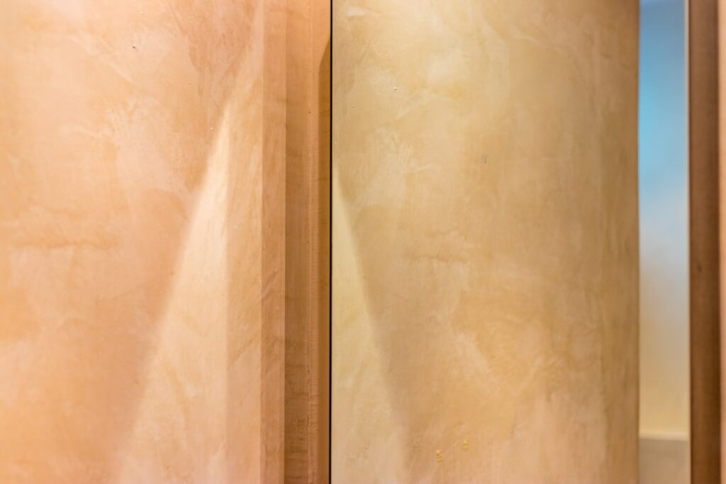 Modern bathroom with wood-look vinyl plank flooring and white freestanding bathtub