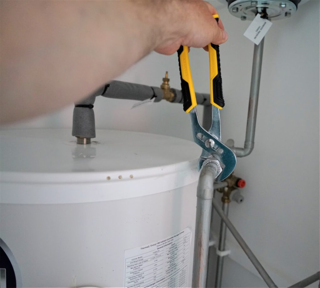 Inside view of a toilet tank showing the flapper valve fill valve and float mechanism