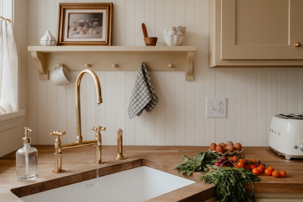 Warm-toned acacia butcher block countertop in a bright kitchen with white cabinets