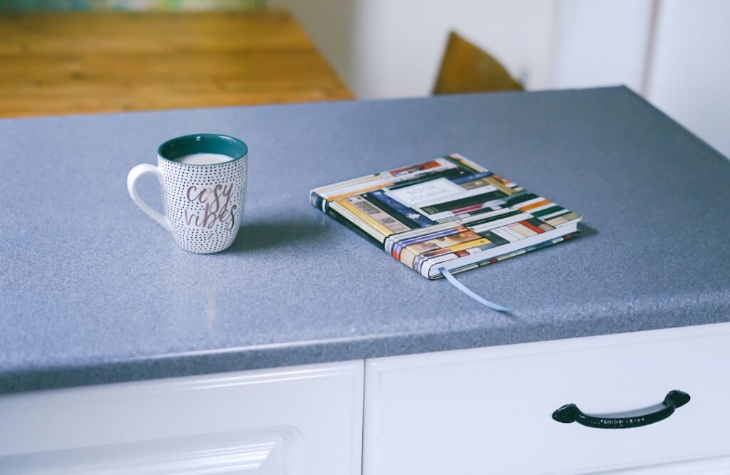 homeowner applying paint to laminate kitchen countertops with a foam roller