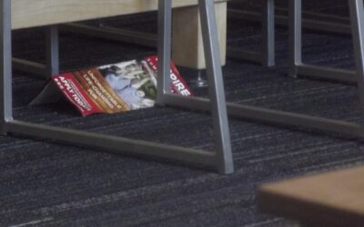 Modular carpet floor tiles arranged in a checkerboard pattern on an office floor