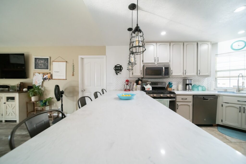 Homeowner applying epoxy coating to DIY countertop in a kitchen renovation