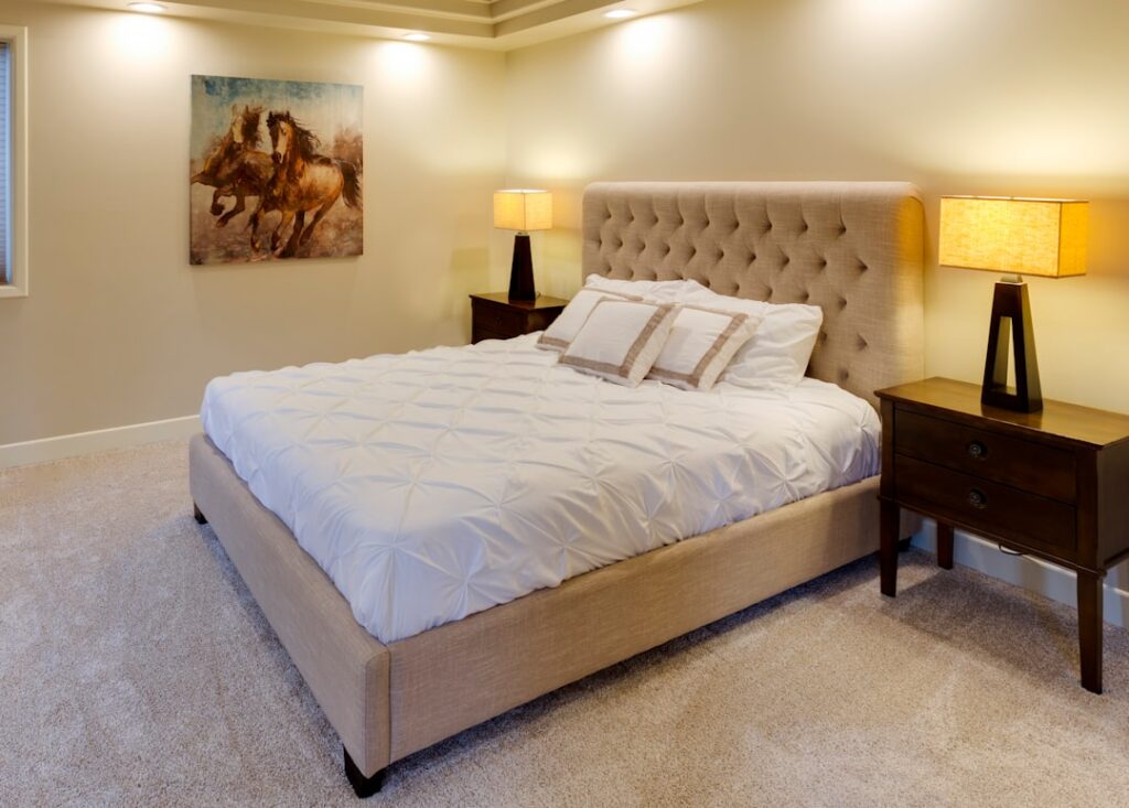 Bedroom with plush fitted wall-to-wall carpet in a neutral beige tone