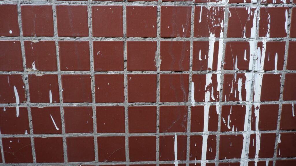 Steam cleaner being used on tile grout lines in a bathroom