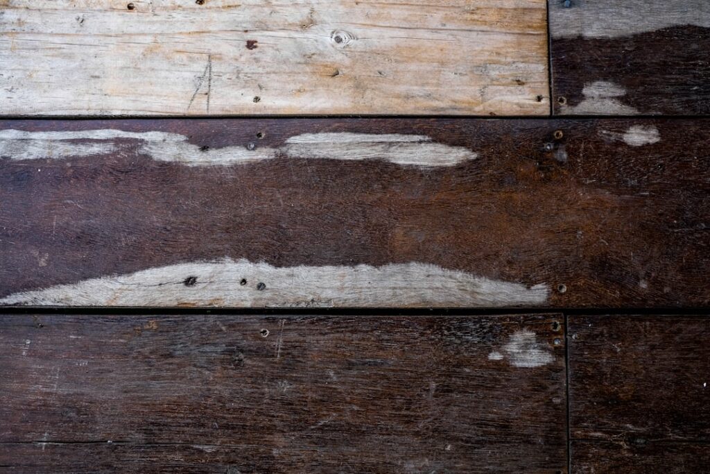 Warped hardwood floor planks showing water damage cupping
