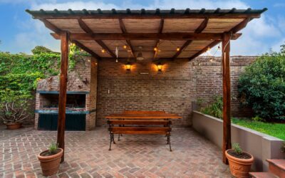 Beautiful wooden pergola over a backyard patio with climbing plants