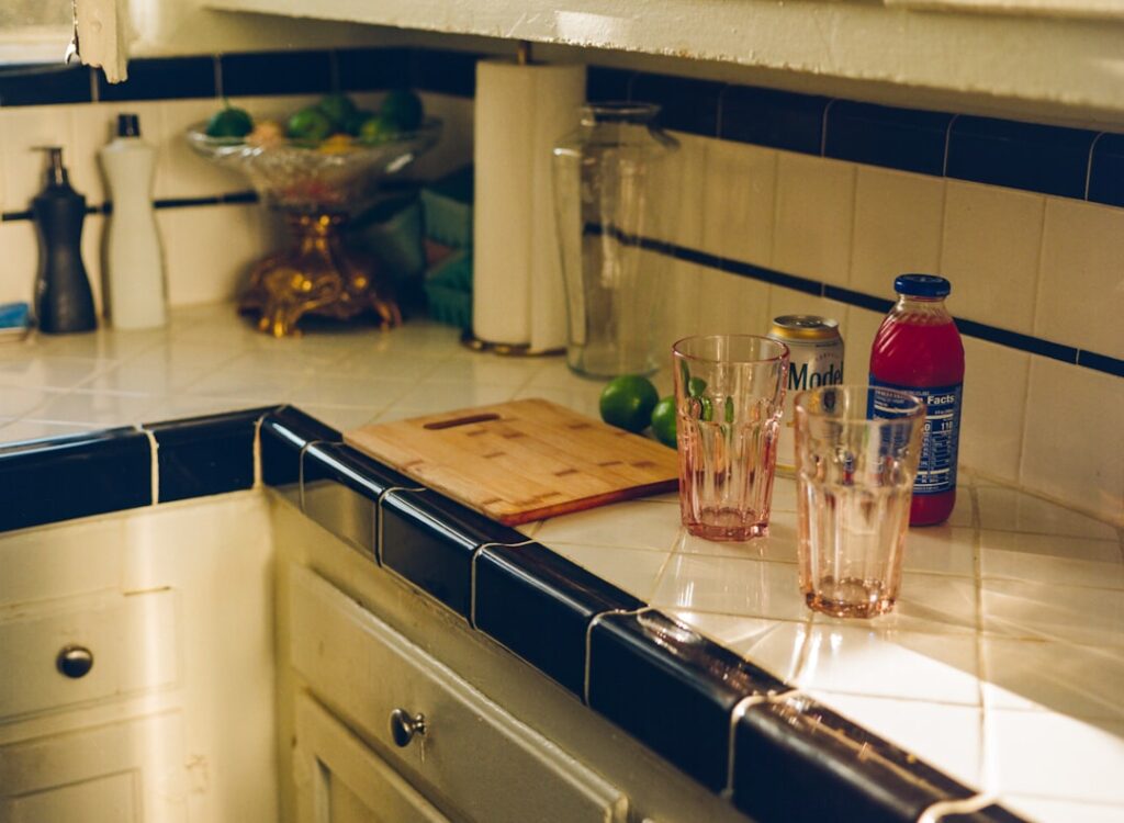 Clean finished backsplash edge on an open kitchen wall with metal trim
