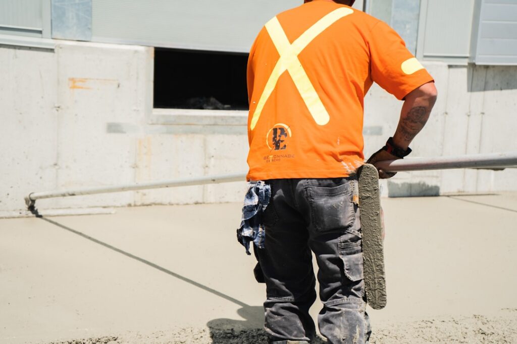 Self-leveling compound being poured on concrete floor in preparation for new flooring
