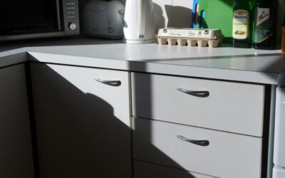 Person repairing a chip on a laminate kitchen countertop
