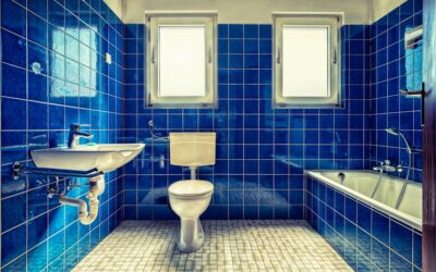 Applying fresh grout between bathroom tiles with a rubber grout float