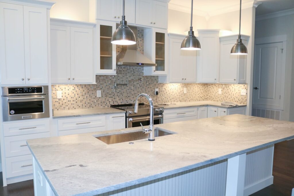 Professional installer measuring granite slab for countertop replacement in a kitchen