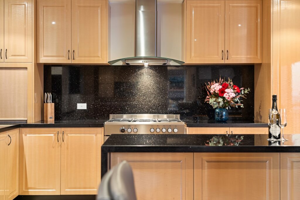 Backsplash With Oak Cabinets & Dark Countertops