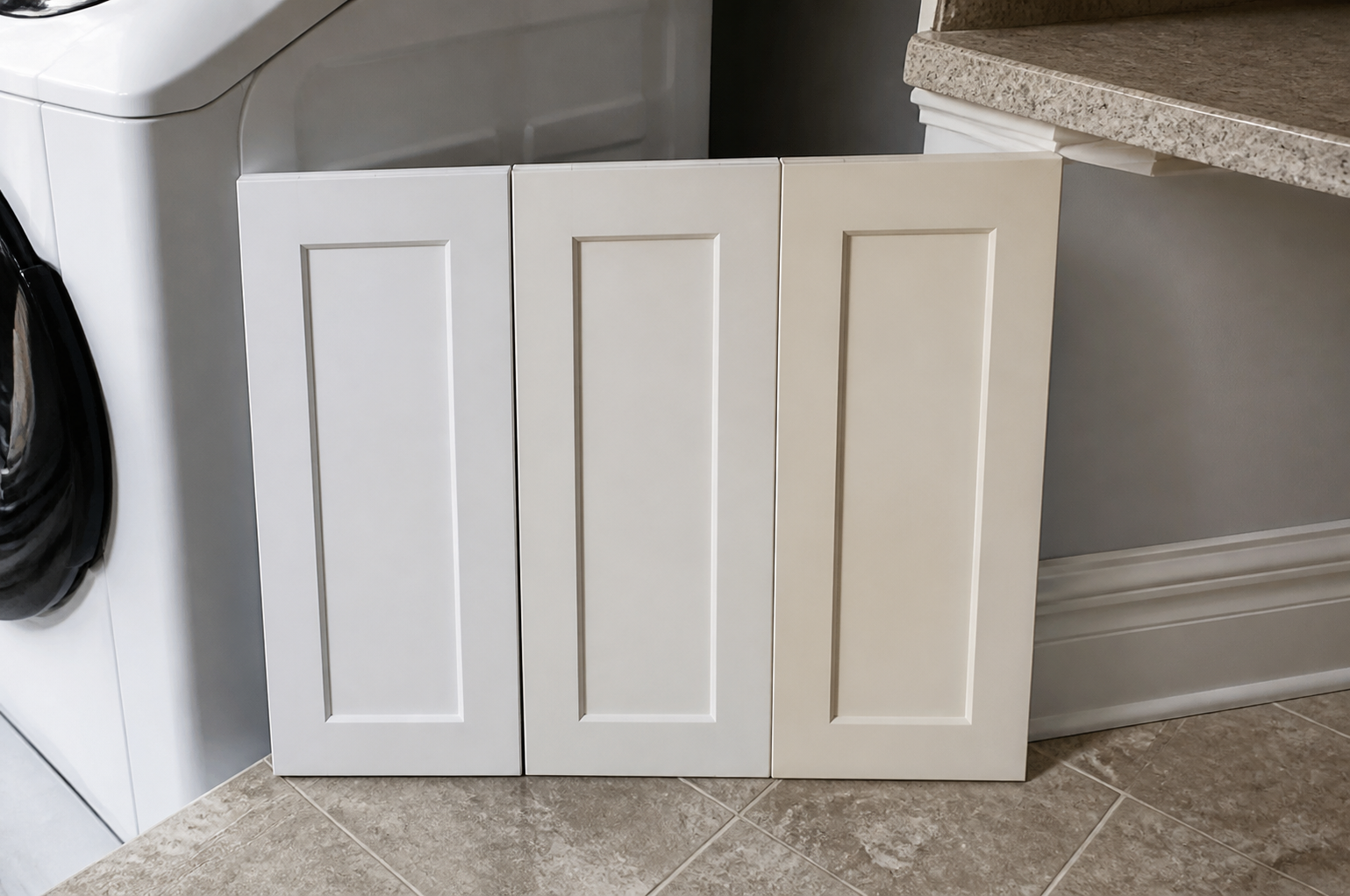 White cabinet door samples compared with appliance enamel, trim, countertop, and floor tile